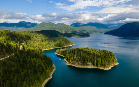Boat moored in a blue ocean next to island aerial view