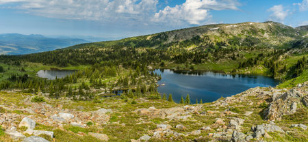 Small lake in the green alpine meadows from aboveの写真素材