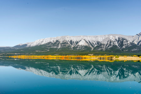High rocky mountains with nicely calm water reflection in a lakeの写真素材