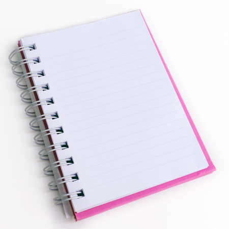 Opened pink note book on white background
