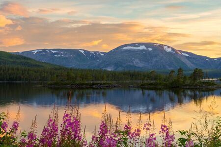 Beautiful sunset scenery of lake and mountain in summer, Norway.