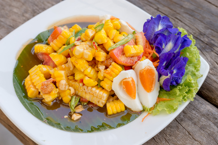 Thai food : Spicy corn salad with salted eggの写真素材
