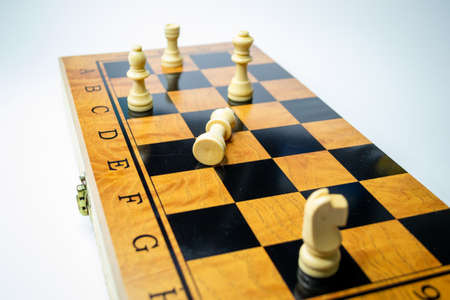 Chess battle on wood board isolated on white background