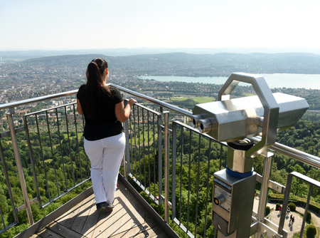 Female tourist enjoying cityscape of Zurich view from Uetliberg, Switzerland.の写真素材