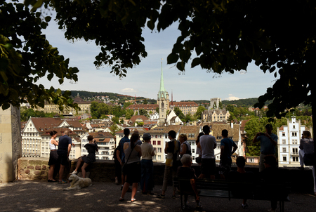 Zurich, Switzerland - June 03, 2017: People are looking at Zurich cityscape from Lindenhof with Predigerkirche church at the background.のeditorial素材