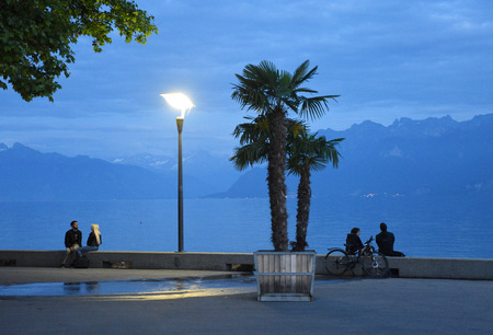 Lausanne, Switzerland - June 05, 2017: People at the embankment on Lake Geneva in evening time, Lausanne, Switzerland.のeditorial素材