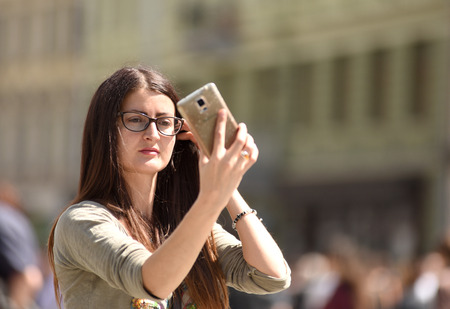 Lviv, Ukraine - May 06, 2017: A girl make selfie sunny day in Lviv, Ukraine.のeditorial素材