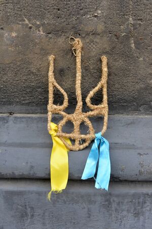 coat of arms of Ukraine from straw, trident, yellow and blue ribbons
