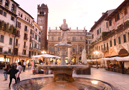 Verona, Italy June 06, 2017: Fountain statue of Madonna Verona (Fountain of our Lady Verona) with Palazzo Maffei and Gardello tower at the background on Piazza delle Erbe  in Verona, Italy.のeditorial素材