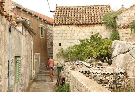 Lastovo, Croatia - August 2017: Man on street of the Lastovo old town.のeditorial素材