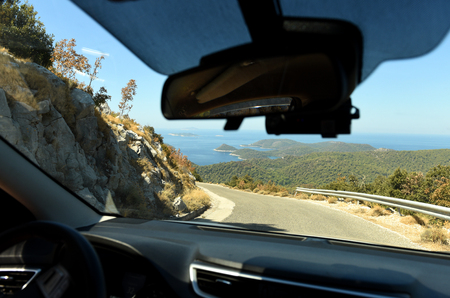 View from the car through the windshield.  road on island, serpentine, trip, Croatiaの写真素材