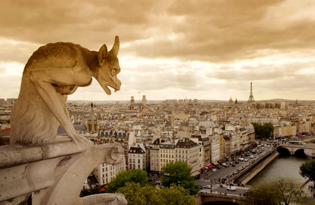 A stone demon gargoyle, statue on the Notre Dame Cathedral,Paris, Franceの写真素材