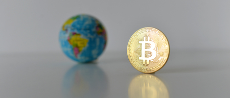 Bitcoin concept. World economy concept. New world currency. Golden coin bitcoin and globe.