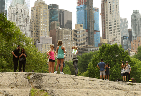 New York, USA - May 26, 2018: People in Central Park and skyscrapers of the Manhattan at the background.のeditorial素材