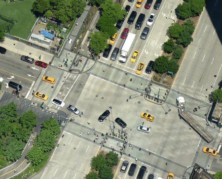 View from skyscrapers on the streets of New York City. Top view on the street with cars on the road