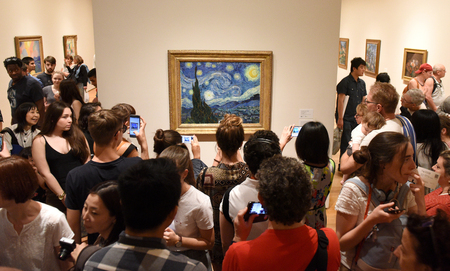 New York, USA - May 25, 2018: Crowd of people near the Starry Night by Vincent van Gogh painting in Museum of Modern Art in New York City.のeditorial素材