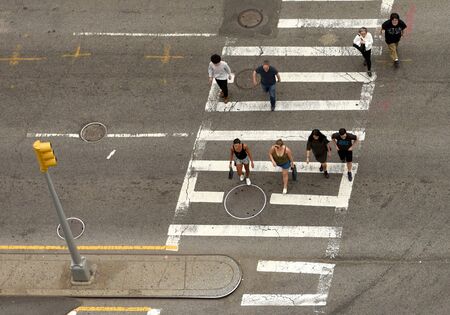 New York, USA - June 9, 2018: People walking on zebra crossings in New York. Looking down from skyscraper on the busy streets in New York.のeditorial素材