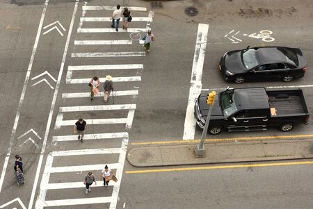 New York, USA - June 9, 2018: People walking on zebra crossings in New York. Looking down from skyscraper on the busy streets in New York.のeditorial素材