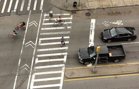 New York, USA - June 9, 2018: People walking on zebra crossings in New York. Top view at the intersection with peope on zebra crossings.のeditorial素材