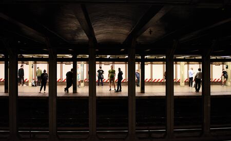 New York, USA - June 8, 2018: People on subway platform waiting for the train in New York.のeditorial素材