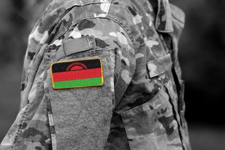 Malawi flag on soldiers arm (collage).の写真素材