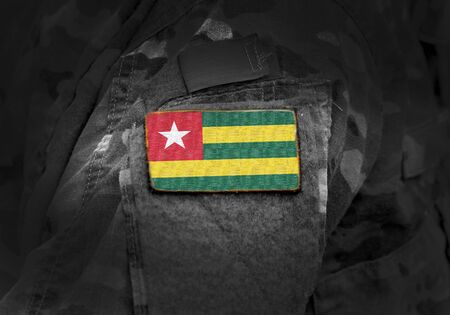 Flag of Togo on military uniform. Army, troops, soldiers. Collage.の写真素材