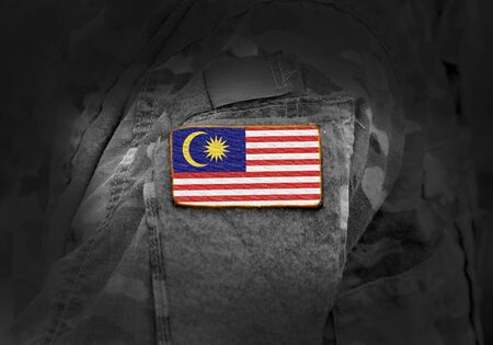 Flag of Malaysia on military uniform. Army, troops, soldiers. Collage.の写真素材