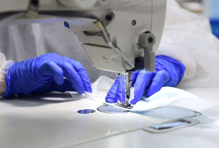 Tailors sew protective face masks. Many people used face masks as a protective measure against the...