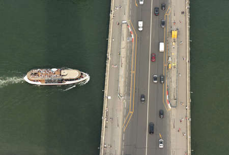 Paris, France - August 28, 2019: Top view from from Eiffel Tower on a bridge and tourist ship on Seine river in Paris.のeditorial素材
