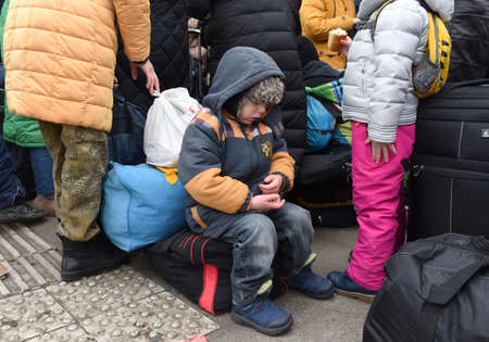 Lviv, Ukraine - March 6, 2022: Refugees near railway station of Lviv waiting for the train to...