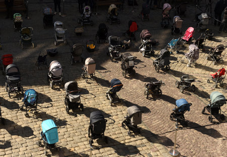 Lviv, Ukraine - March 18, 2022: 109 empty strollers are seen placed outside the Lviv city council...
