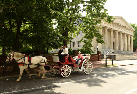 Philadelphia, USA - May 29, 2018: The tourists in a carriage and Second Bank of the United States Portrait Gallery at the background.のeditorial素材