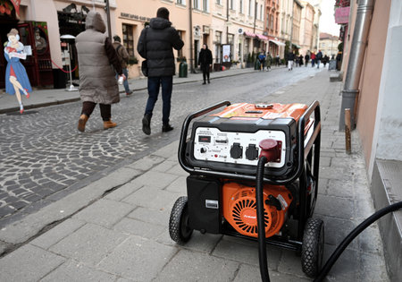 Lviv, Ukraine - Dec 29, 2022: A electricity generator outside a store during a power outage following Russian missile strikes.のeditorial素材