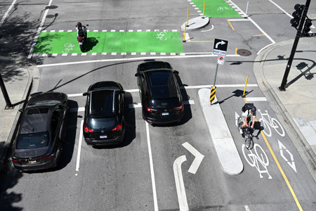 Vancouver, BC, Canada - August 15, 2023: Top view at the cars go through the intersection in...