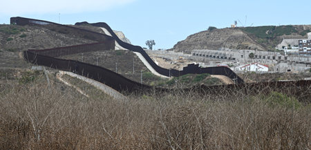 San Ysidro, CA, USA - July 30, 2023: The USA Mexico Border Wall near Border Field State Park Beach.