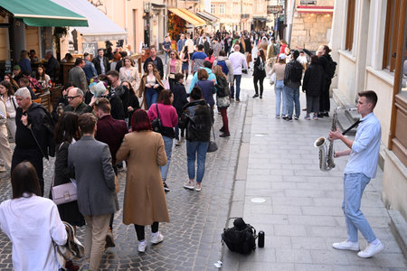 Lviv, Ukraine - April 23, 2023: A street musician performs in center the city of Lviv.