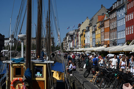 Copenhagen, Denmark - August 1, 2024: A crowd of people on the New Harbour (Nyhavn) waterfront,...