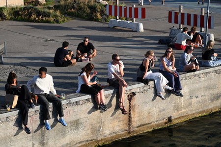 Copenhagen, Denmark - July 31, 2024: A people rest on waterfront canal of Copenhagen in sunny day.のeditorial素材