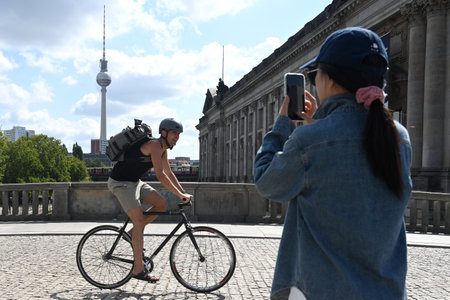 Berlin, Germany - August 3, 2024: A cyclist on the street of Berlinのeditorial素材