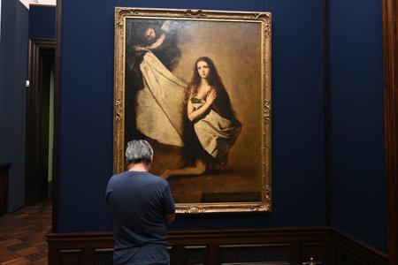 Dresden, Germany- August 30, 2024: Visitor near the Saint Agnes by Jusepe de Ribera painting in the Old Masters Gallery (Gemaldegalerie Alte Meister) in Dresden, Germany.のeditorial素材