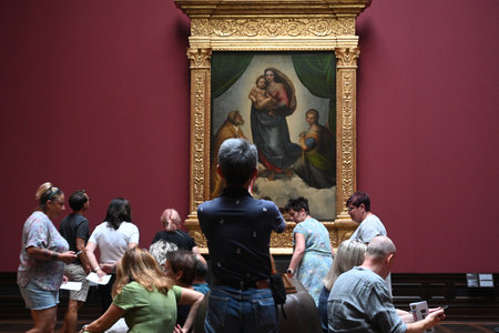 Dresden, Germany- August 30, 2024: Visitors near the Sistine Madonna by Raphael painting in the Gemaldegalerie Alte Meister (Old Masters Gallery) in Dresden, Germany.のeditorial素材