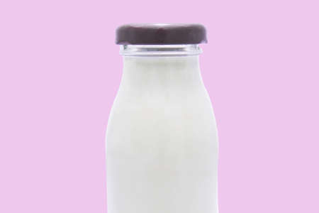 Bottle of milk isolated on pink backgroundの写真素材