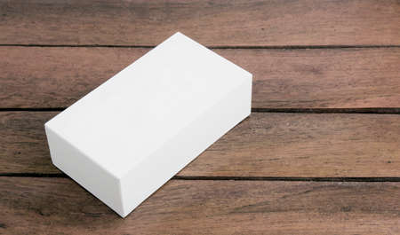 white box on wood background. close up