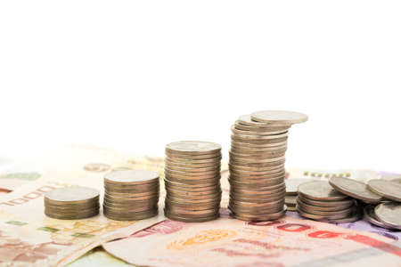 Baht coins on banknote money growing to success backgroundの写真素材