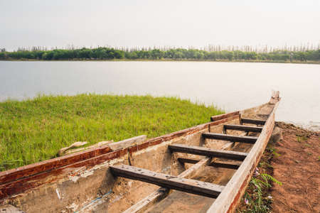 Boat parking at the coast into the lake at dawnの写真素材