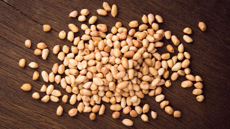 close up peanuts on wooden table. top view.