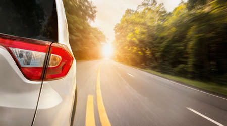 Close up back of car is running on asphalt road in summer to go travel relax in the holidayの写真素材