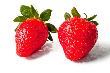 Red ripe strawberries isolated on white background with water dropletの写真素材