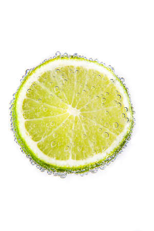 Isolate lime in the water with bubblesの写真素材