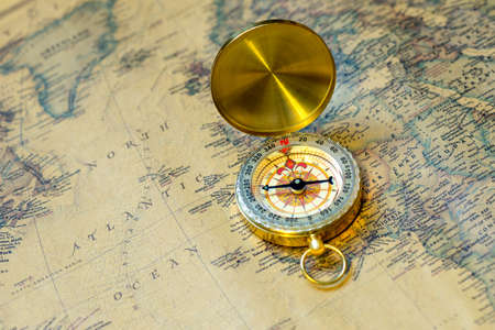 old gold compass with cover on vintage map, macro backgroundの写真素材